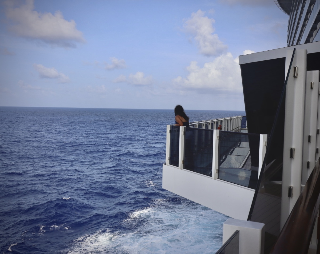 Shriya on a cruise deck, looking out at the ocean